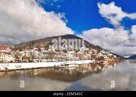 Heidelberg, Germany - February 2021: Neckar river and Odenwald forest hill called Heiligenberg with historical mansions covered in snow. Stock Photo