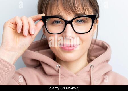 Portrait of a young woman in glasses looking at the camera. Stock Photo