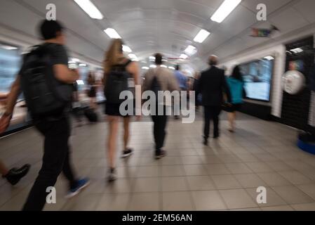 Random unrecognized people at the underground railway tube station during rush hour. Stock Photo