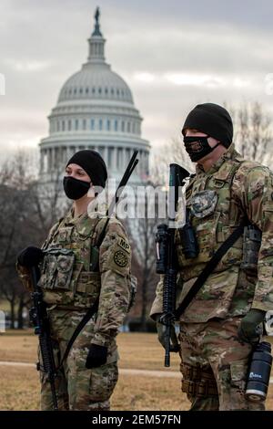 Washington, United States. 23rd Feb, 2021. U.S. Army Pfc. Rebekah Bouman, left, and Sgt. Benjamin Stroll, both military policemen with the 46th Military Police Company, stand watch near the U.S. Capitol February 23, 2021 in Washington, DC The National Guard will continue supporting federal law enforcement agencies with security around the Capitol until the end of March. Credit: Planetpix/Alamy Live News