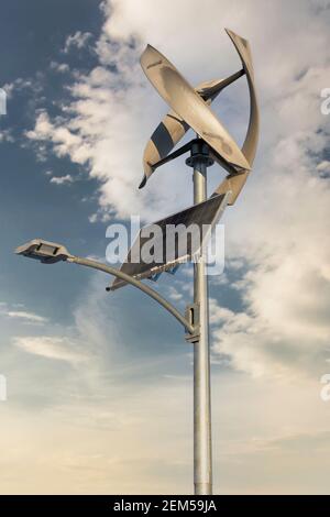 A modern vertical wind turbine and solar panel produce renewable energy in Airdrie Alberta Canada. Stock Photo