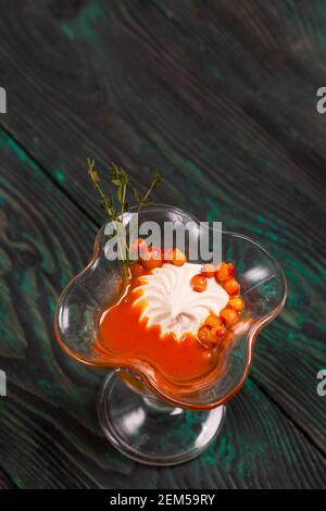 Sea buckthorn marshmallow in bowls. Decorated with sea buckthorn jelly and berries. Stock Photo