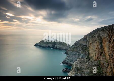 The South Stack Lighthouse is built on the summit of a small island off the north-west coast of Holy Island, Anglesey, Wales Stock Photo