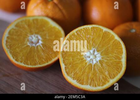 Kinnows and Sliced Kinnows which looks like Orange. It is a high yield, seedless mandarin hybrid orange like fruit cultivated extensively in the wider Stock Photo