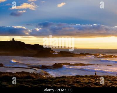 Sunset below the clouds and blue sky above, Bude, Cornwall, UK Stock Photo