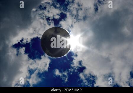Solar Eclipse and clouds. Solar eclipse, natural phenomenon when Moon passes between planet Earth and Sun. Elements of this image furnished by NASA. Stock Photo