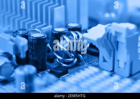 Closeup of electronic circuit board with inductor coil and capacitor. Stock Photo