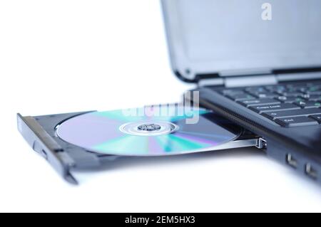 Laptop with a disk dvd in the tray Stock Photo