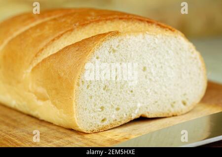 Close up of a long loaf on a cutting board Stock Photo