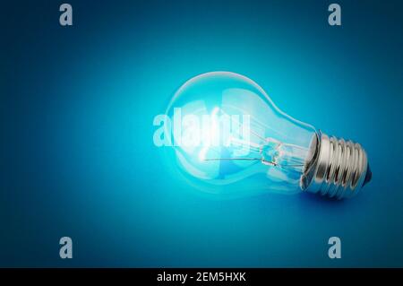 Electric light bulb on a blue background Stock Photo