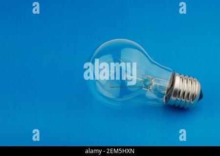 Electric light bulb on a blue background. Stock Photo