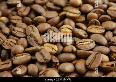 Closeup roasted coffee beans background. Selective focus. Roasted coffee beans background. Stock Photo