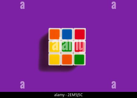 Rubiks Cube on a purple background Stock Photo