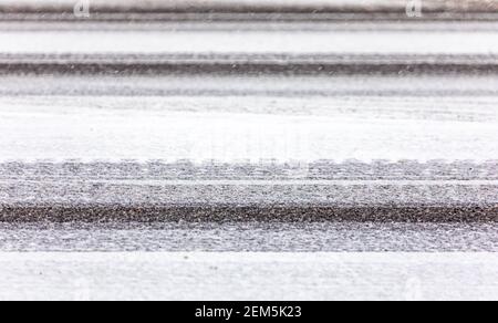 Detail image of snow on an asphalt road Stock Photo