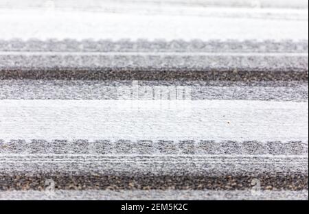 Detail image of snow on an asphalt road Stock Photo