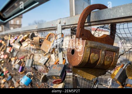 Handmade, artistic padlock  on the Father Bernatek Footbridge (Kładka Ojca Bernatka),  Lovers bridge over the Vistula River. Krakow, Poland. Stock Photo