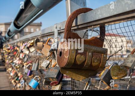 Handmade, artistic padlock  on the Father Bernatek Footbridge (Kładka Ojca Bernatka), Lovers bridge over the Vistula River. Krakow, Poland. Stock Photo