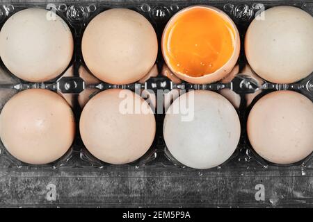 Flat lay closeup view raw and soft boiled eggs on plastic box Stock Photo