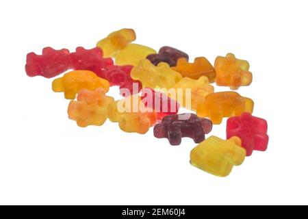 Multicolored chewy figured marmalade in the form of puzzles isolate on a white background close-up. Stock Photo