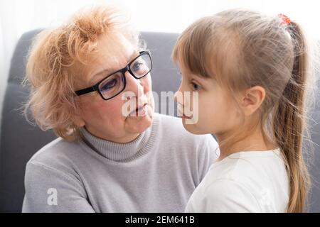 Cheerful woman taking care of her grandmother At Home. Stock Photo