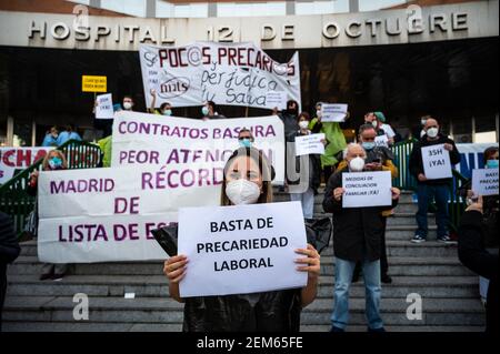 Madrid, Spain. 24th Feb, 2021. Healthcare workers protesting with placards against precariousness in front of 12 de Octubre Hospital demanding better working conditions and against their mistreatment during the coronavirus (CIVID-19) pandemic. Health workers are wearing trash bags as a symbol of protest. Credit: Marcos del Mazo/Alamy Live News Stock Photo