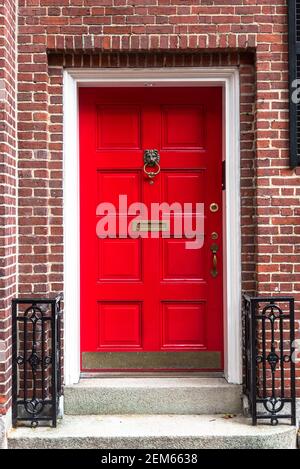 Close up of a traditional red wooden front door of an old brick house Stock Photo