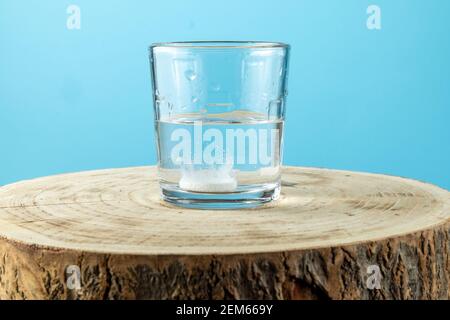 Putting effervescent pill into glass full of water Stock Photo