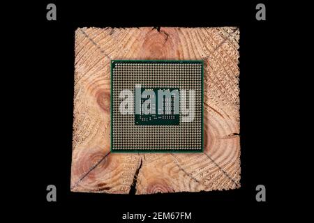 A personal computer processor stacked on raw wood. Accessories and spare parts for computer repair. Dark background. Stock Photo