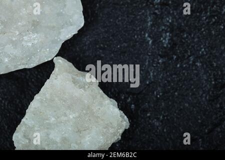 Crystalized salt rocks on dark background. Close up Stock Photo
