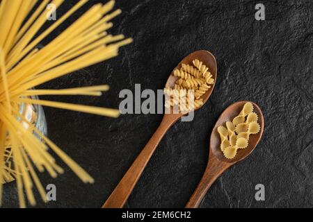 Three types of uncooked pasta on a black background Stock Photo