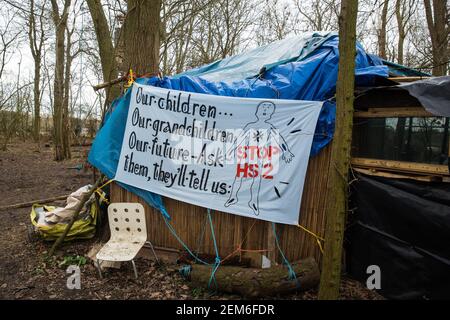 Steeple Claydon, UK. 24 February, 2021. An anti-HS2 banner is pictured in ancient woodland known as Poors Piece during an operation by Thames Valley Police to remove activists opposed to the HS2 high-speed rail link on behalf of HS2 Ltd. The activists created the Poors Piece Conservation Project there in spring 2020 after having been invited to stay on the land by its owner, farmer Clive Higgins. Already, local village communities have been hugely impacted by HS2, with 550 acres of land seized including a large section of a nature reserve. Credit: Mark Kerrison/Alamy Live News Stock Photo