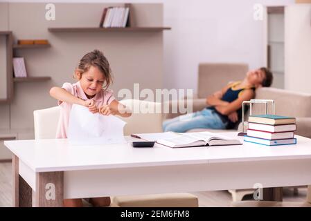 Teenager and his small sister staying at home during pandemic Stock Photo