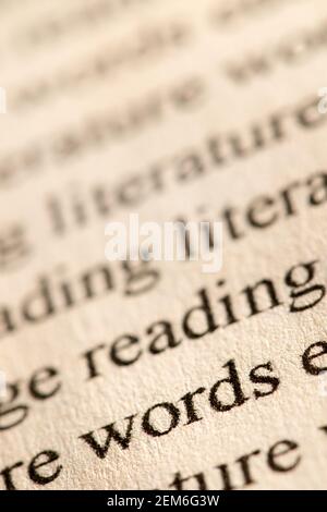 Close up of the word literacy typed in traditional font and printed in black ink on parchment style ink jet paper. Stock Photo