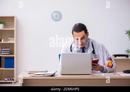 Young doctor lecturer cardiologist working in the clinic Stock Photo