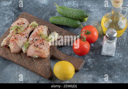 Raw chicken drumsticks with vegetables and spices Stock Photo