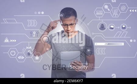 Male Asian programmer with tablet computer creating software for data protection Stock Photo