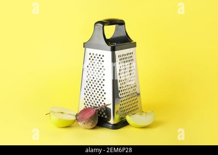 Metal grater, cut apples and beetroot on color background Stock Photo