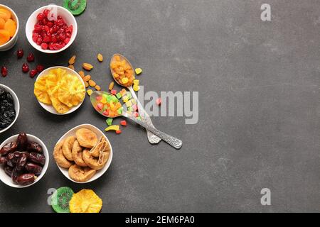 Bowls with different dried fruits on dark background Stock Photo