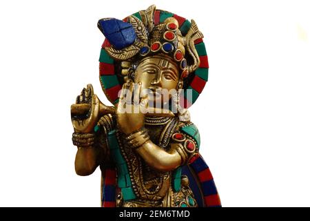 Close-up view of Indian god Krishna idol playing bansuri or wind blowing musical instrument Stock Photo