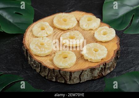 Dried pineapple rings on wooden piece Stock Photo