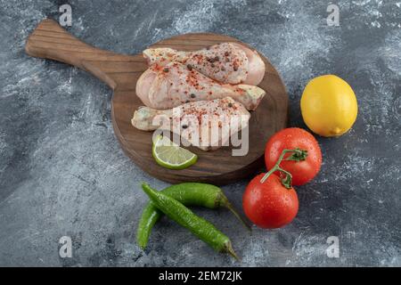 Fresh vegetables with chicken drumsticks ready to cook Stock Photo