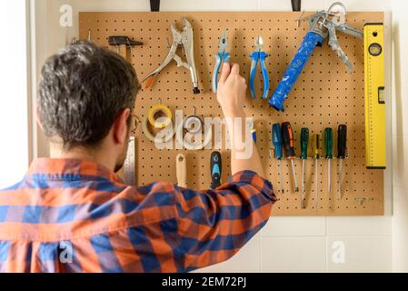 various construction tools hanging on the wall. High quality photo. Stock Photo