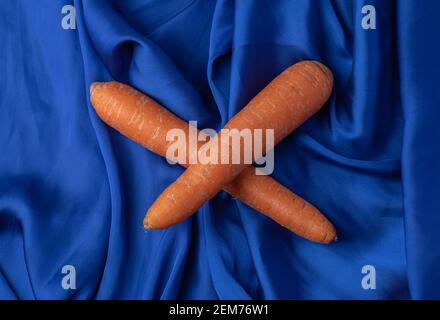 Two fresh carrots on blue background Stock Photo