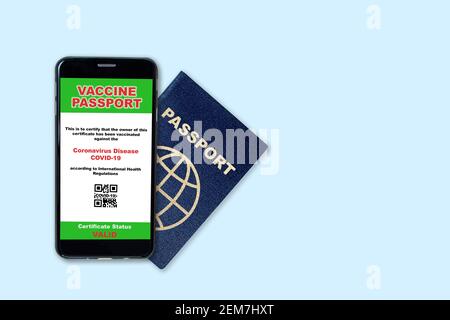 Smartphone on travel passport showing digital certificate of COVID-19 vaccination. Concept of vaccine passport in the new normal future air or land tr Stock Photo