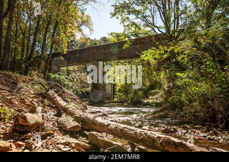 Cullman, Alabama/USA-Oct. 17, 2020: Long exposure shot of Crooked Creek with the Clarkson Covered Bridge in the background and sun spots visible. Stock Photo