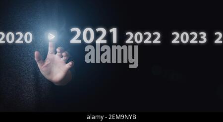 Hand presses virtual inclusion button on dark background. Concept of 2021 year Stock Photo