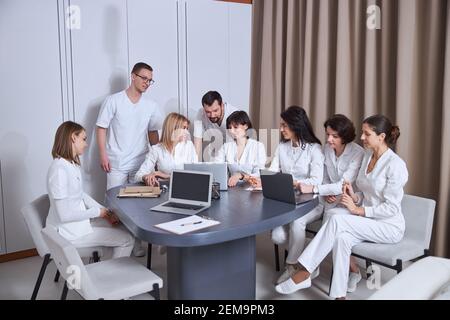 Doctors discussing their patient cases at a brief meeting Stock Photo