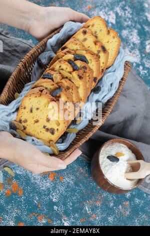 Sliced pie on a blue towel in a wooden basket Stock Photo