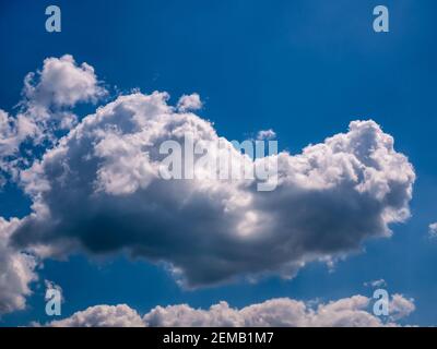 Real fluffy cloud-shaped heart on a dark blue sky. Stock Photo