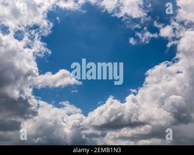 Hole of blue sky in the fluffy clouds in the sky. Stock Photo
